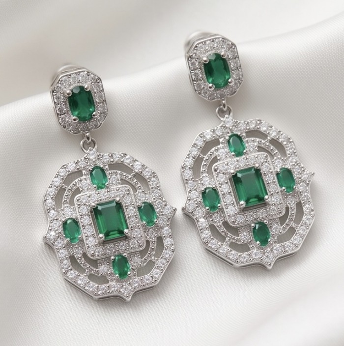 Art Deco - 8.8 carat Colombian Emerald .925 Sterling Silver handmade Statement Earrings - Art Deco earrings with emeralds, front view, on a white fabric background.