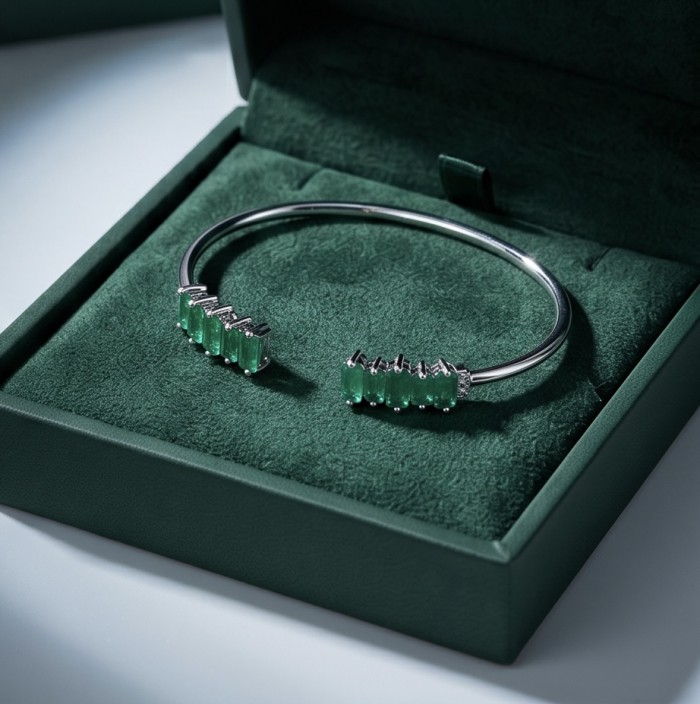 Art Deco 8.2 carat genuine Ruby .925 Sterling Silver handmade Statement Bracelet - Silver bracelet with emerald stones in green velvet box, angled view.