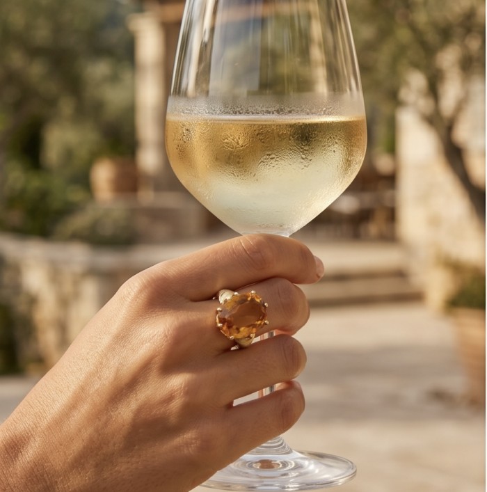 22.8 carat Genuine Heliodor 18K Gold over .925 Sterling Silver handcrafted ring size 10 - Heliodor ring worn on hand holding a wine glass, outdoor setting.