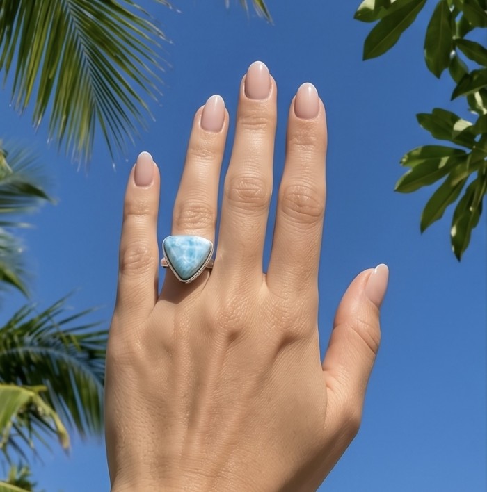 Paradise 18.9 carat natural Larimar .925 Sterling Silver handmade Large ring size 8 adjustable - Larimar ring on hand against blue sky and palm leaves background.