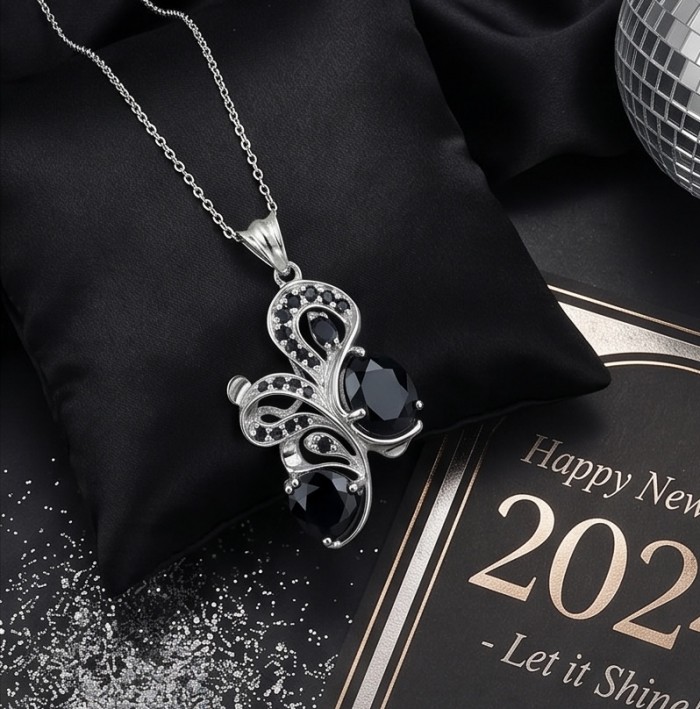 Mademoiselle - 14.4 carat natural Amethyst .925 Sterling Silver dipped in rhodium handcrafted Pendant - Silver necklace with black stones on a black cushion, overhead view.