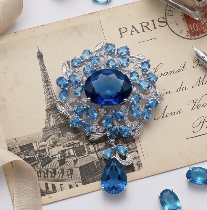 An exuberantly Large 58.2 grams Vintage style Swiss Blue Topaz .925 Sterling Silver DIPPED IN RHODIUM handmade LARGE Pendant - Brooch - Ornate brooch with blue gemstones on vintage Paris postcard background.