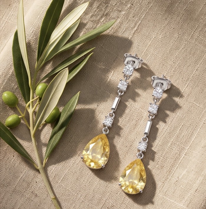 Luxurious pear cut 8.5 carat Yellow Sapphire rhodium over .925 Sterling Silver handcrafted earrings - Yellow sapphire drop earrings with olive branches, top view.