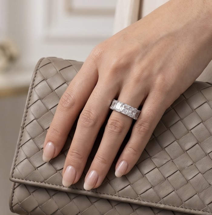 Eternity- 14.8 carat White Topaz Silver tone handcrafted Soild ring size 6 - Hand with Eternity ring, 14.8 carat white topaz, holding woven clutch