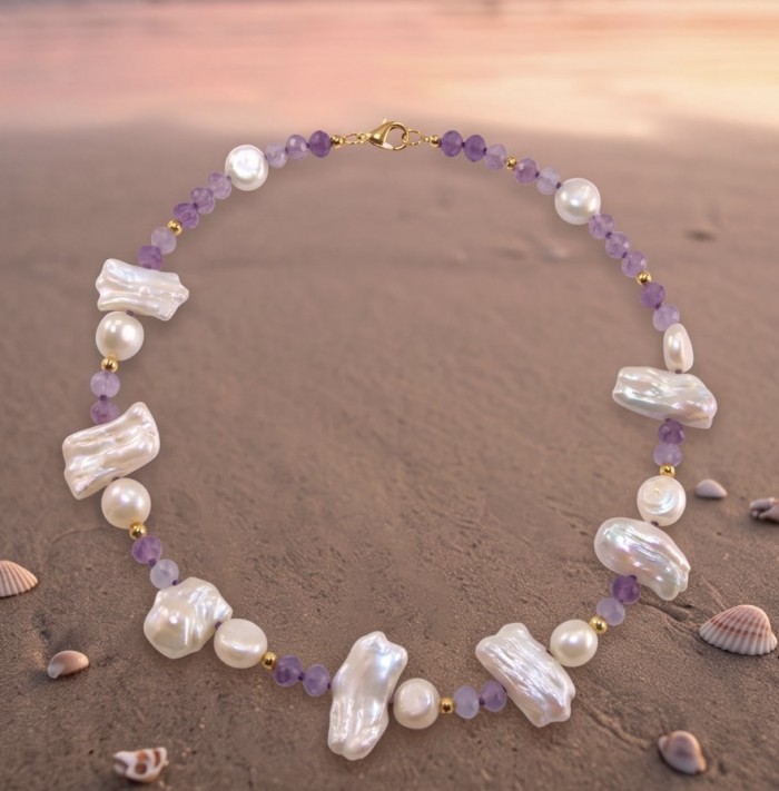 Colors of the Ocean - Outstanding MOTHER OF Pearl .925 Sterling Silver diped in 14K Gold handcrafted Statement necklace - Necklace on sand, showcasing pearls and purple beads, beach background.