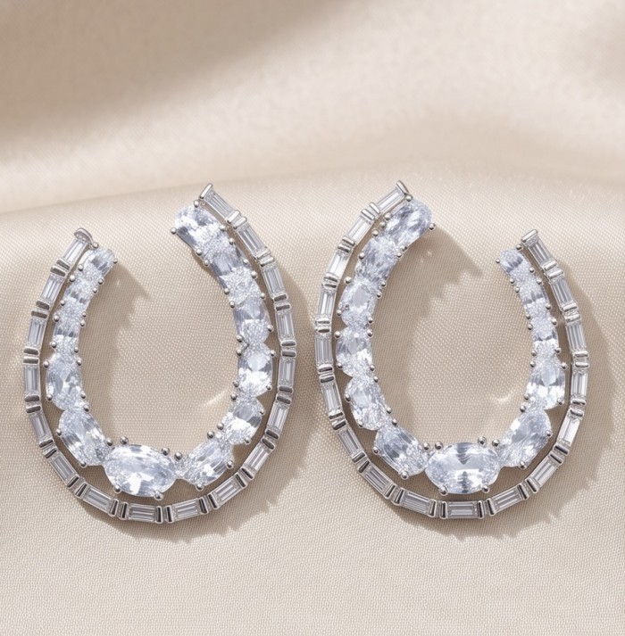 Elizabeth Natural 5.2 carat Moissanite .925 Sterling Silver handcrafted earrings - Close-up of Elizabeth Moissanite earrings on a soft beige background.