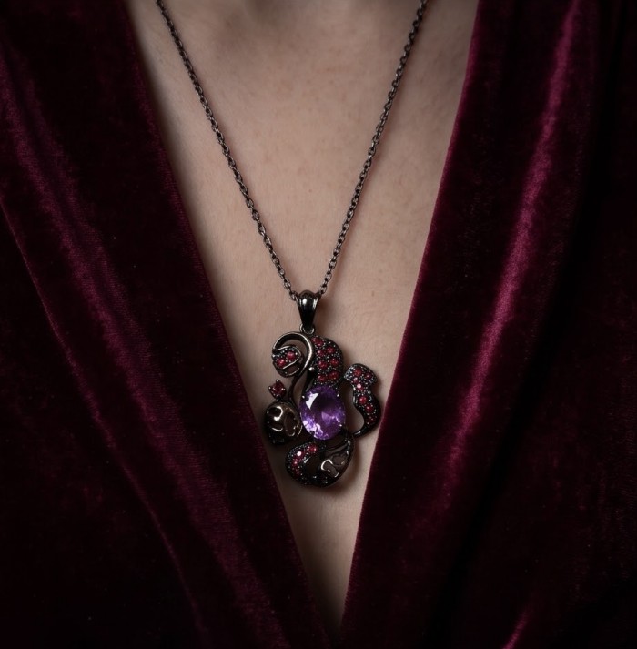 Beautiful Mystery 8.8 carat Precious Amethyst .925 Sterling Silver dipped in black rhodium handcarfted Pendant - Necklace with amethyst and red stones worn over burgundy velvet.