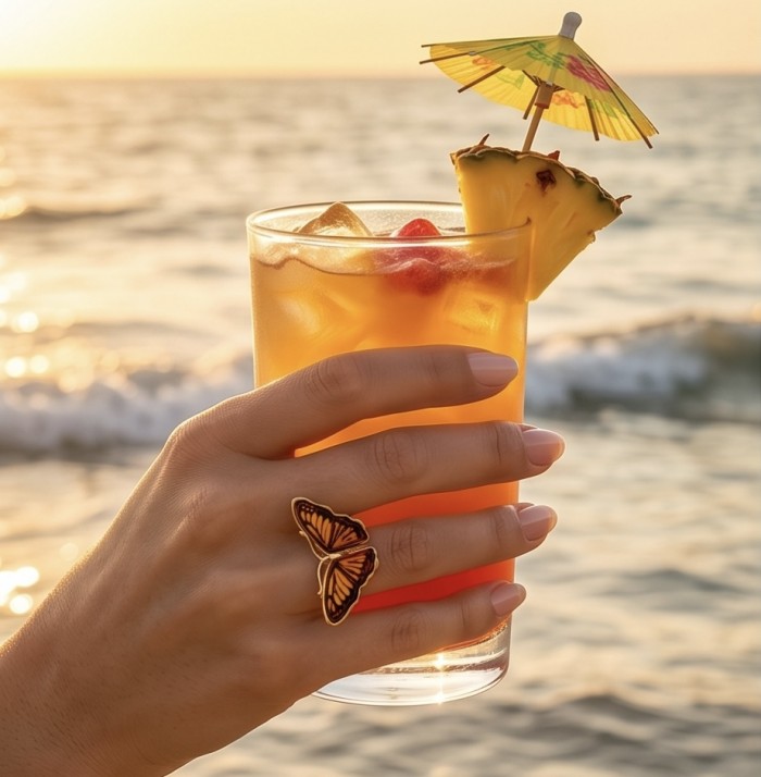 Butterfly Authentic Baltic Amber .925 Sterling Silver dipped in 18K Gold handcrafted ring; s. 6 adjustable - Butterfly amber ring worn on hand holding a cocktail by the beach.
