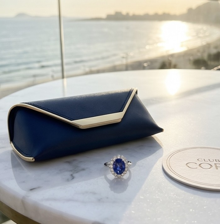 Royalty Design oval cut 24.9 CARAT Tanzanite .925 Sterling Silver Statement Ring s. 9 1/4 - Tanzanite ring and blue case on table with coastal background.