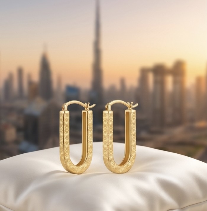Black Label Collection - Dubai Style - Natural 22K Gold over .925 Sterling Silver handmade earrings - Gold hoop earrings on display with a city skyline backdrop