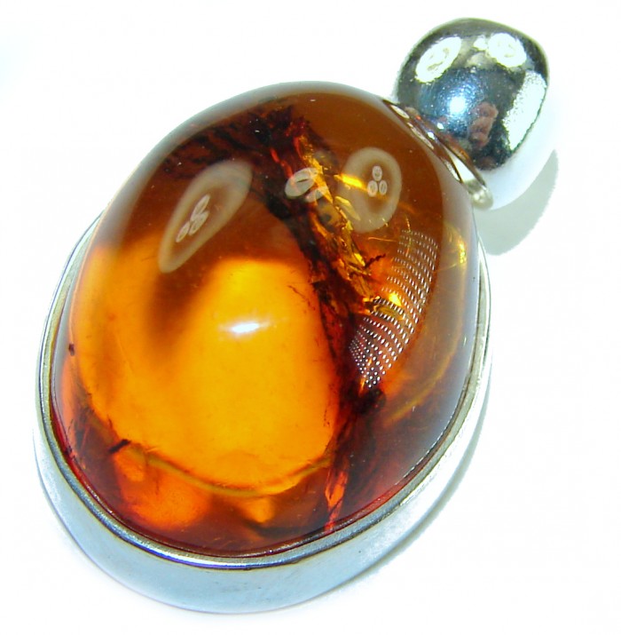 Prehistoric Authentic Baltic Amber .925 Sterling Silver beautifully handcrafted Pendant - Stone close-up of Baltic amber set in .925 sterling silver bezel.