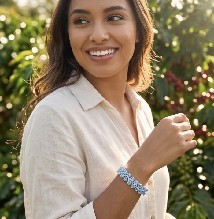 Serenity 88.9 carat genuine Swiss Blue Topaz .925 Sterling Silver handmade Large Statement Bracelet - Woman wearing Serenity Blue Topaz bracelet, garden background.