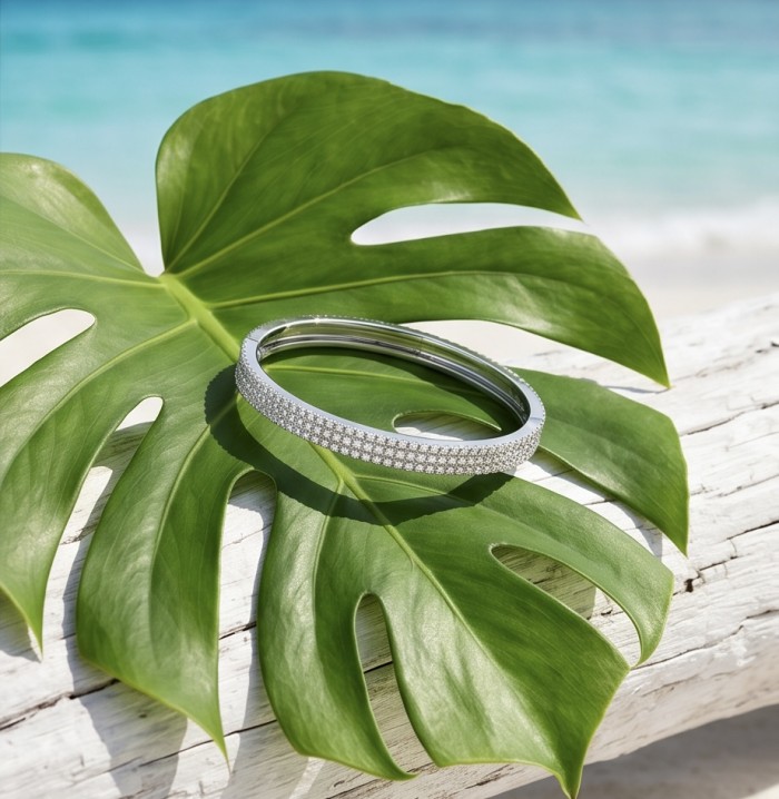 Veronica - Precious 6.7 carta White Topaz rhodium over .925 Sterling Silver Statement bracelet - Bangle on leaf, beach backdrop, side view of White Topaz bracelet