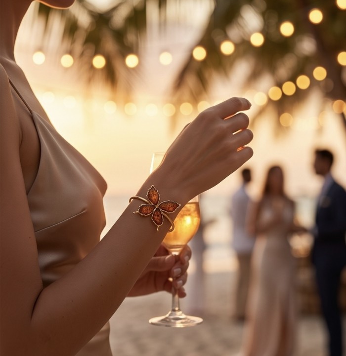 Golden Butterfly Genuine carved Baltic Amber .925 Sterling Silver dipped in 18K Gold handamde Bracelet - Worn on hand, golden butterfly amber bracelet with warm beach lighting.