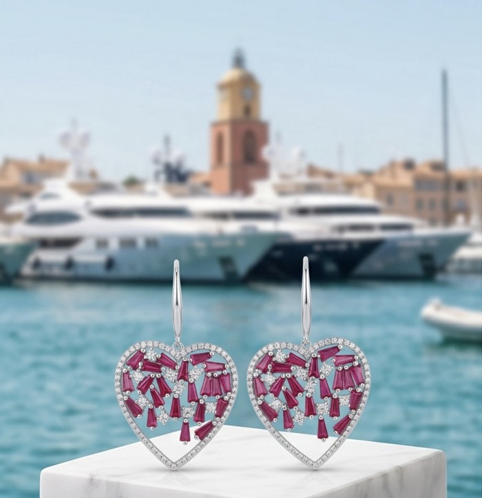 Precious Hearts - authentic 12.5 carat Mozambique Ruby .925 Sterling Silver dipped in rhodium handcrafted Statement Earrings - Heart-shaped earrings with rubies, front view, yachts in background.