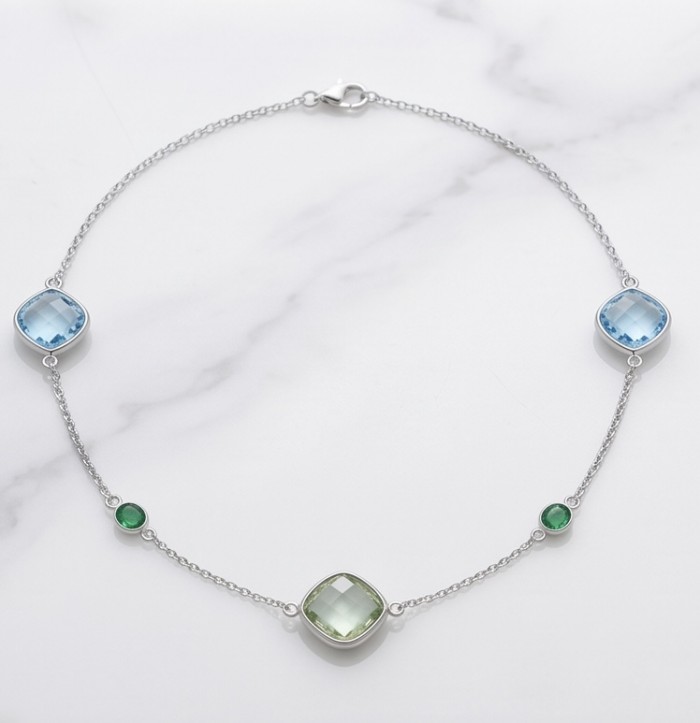 Infinity 18.5 carat Authentic Multigems Rhodium over .925 Sterling Silver handcrafted Statement necklace - Elegant multigem necklace on marble background, showcasing side view.