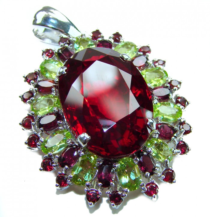 Victorian style 28.5 carat Authentic Ruby .925 Sterling Silver handcrafted Pendant - Close-up of Victorian style ruby pendant with green gemstone accents.