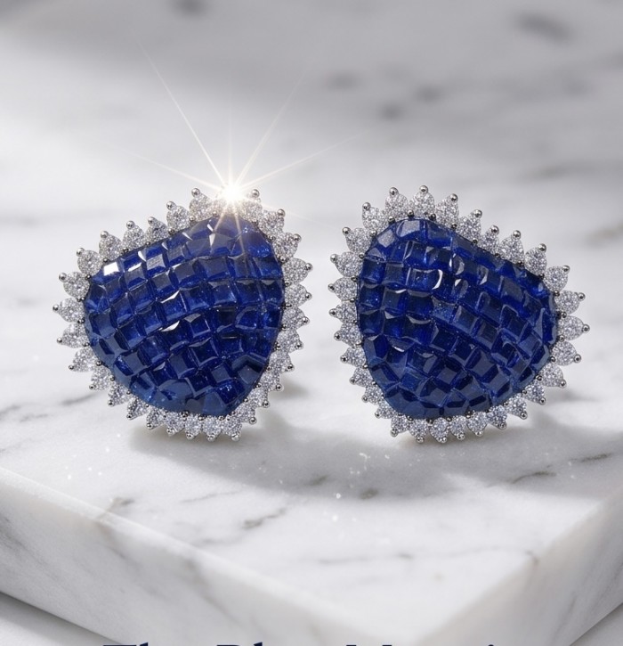Precious Hearts mystery setting 11.8 carat Sapphire .925 Sterling Silver earrings - Blue heart-shaped sapphire earrings with diamond edges, top view close-up.