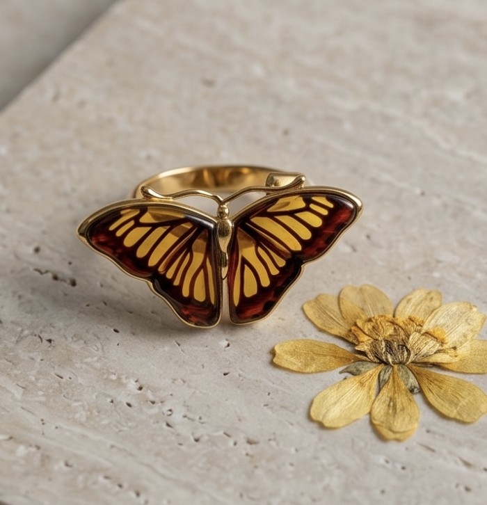 Butterfly Authentic Baltic Amber .925 Sterling Silver dipped in 18K Gold handcrafted ring; s. 7 adjustable - Butterfly amber ring on stone surface with dried flower detail