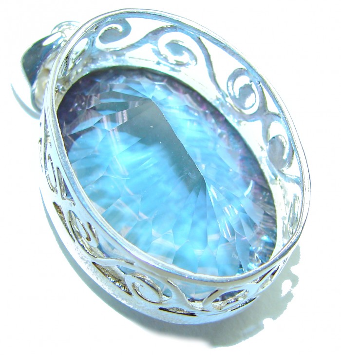 Blue Wonderland 49.7 carat oval cut Mystic Aurora Topaz .925 Sterling Silver handcrafted Pendant - Close-up of Blue Wonderland Mystic Aurora Topaz in ornate silver setting.