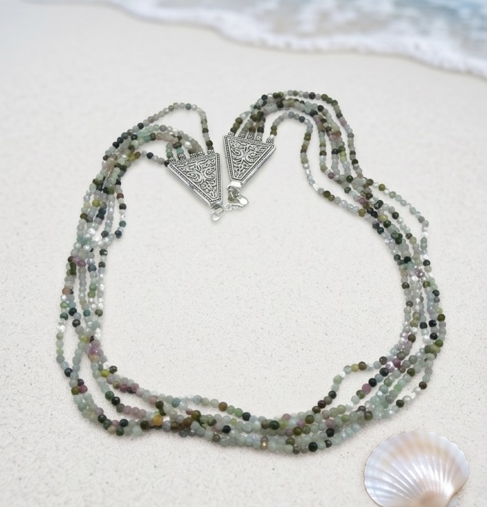 Infinity authentic 44.5 carat Brazilian Tourmaline .925 Sterling Silver handcrafted necklace - Top view of multistrand Brazilian tourmaline necklace on sand.