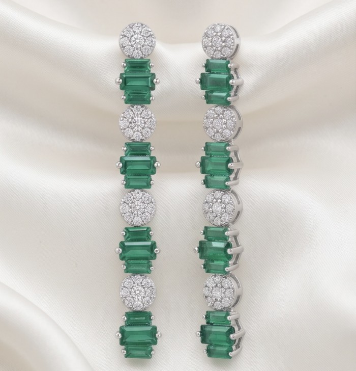 Art Deco 2.5 carat Emerald .925 Sterling Silver handcrafted earrings - Art Deco emerald earrings front view on white fabric background.
