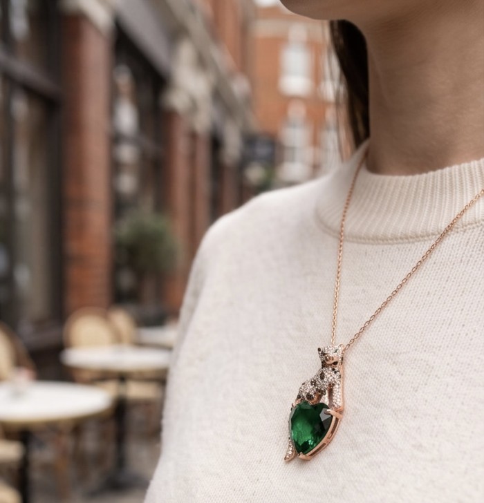 Precious Cheetah authentic 38.5 carat EMERALD .925 Sterling Silver dipped in 14K Rose Gold Handcrafted pendant brooch - Necklace with cheetah pendant and emerald stone, worn on a person.
