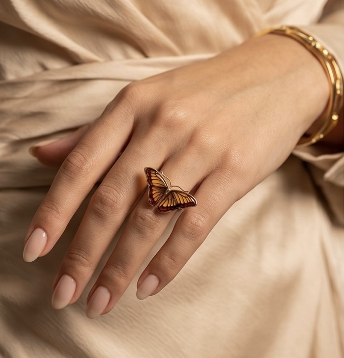 Butterfly Authentic Baltic Amber .925 Sterling Silver dipped in 18K Gold handcrafted ring; s. 7 adjustable - Butterfly amber ring in sterling silver worn on hand, close-up view.