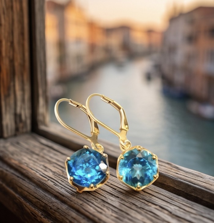 Blue Magic 8.5 carat London Blue Topaz 22K Gold over .925 Sterling Silver handmade Statement earrings - Blue Magic earrings on wooden ledge with canal view in background