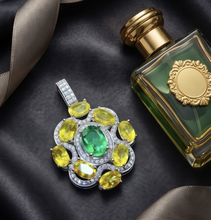 Giovanna - 12.5 carat Authentic Brazilian Peridot .925 Sterling Silver handcrafted Pendant - Flat lay of gemstone pendant and perfume bottle on satin fabric.