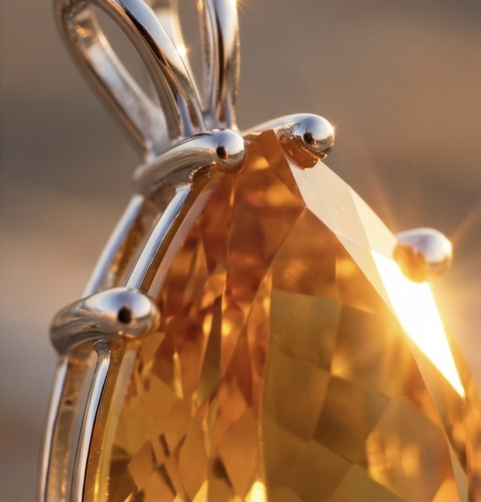 Oval cut 22.5 carat Lemon Quartz rhodium over .925 Sterling Silver handcrafted pendant - Close-up of oval cut Lemon Quartz in rhodium over sterling silver.