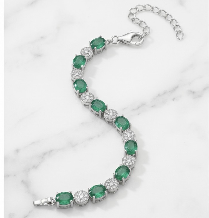 Art Deco 6.7 carat Emerald .925 Sterling Silver handcrafted Bracelet - Emerald bracelet on marble, featuring clasp and stone details.