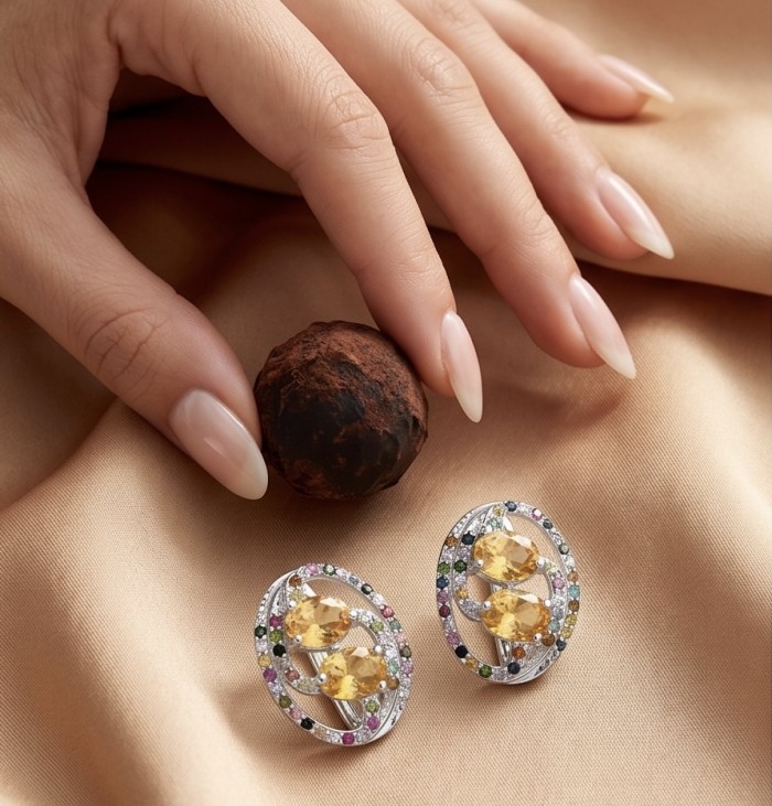 Vivien Luxurious Style - Natural 9.7 carat Citrine .925 Sterling Silver dipped in rhodium handmade earrings - Close-up of Vivien earrings and hand holding a chocolate truffle.