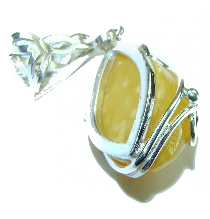Prehistoric Authentic Butterscotch Baltic Amber .925 Sterling Silver beautifully handcrafted Pendant - Close-up of butterscotch Baltic amber pendant with silver wrap detail.