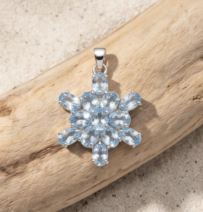 Blue Star 11.4 carat genuine Swiss Blue Topaz .925 Sterling Silver handmade Statement Pendant - Blue star pendant on wood, front view, 11.4 ct Swiss Blue Topaz in sterling.