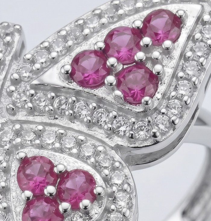 Giovanna - Authentic 1.9 carat Ruby .925 Sterling Silver dipped in rhodium handcrafted Statement Ring size 8 - Close-up of rubies and diamonds on butterfly-shaped silver jewelry.