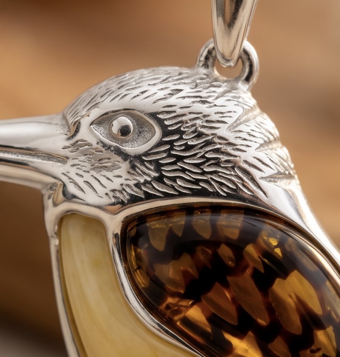 Summer Bird Amber .925 Sterling Silver handmade Pendant - Close-up of bird pendant with amber detail in sterling silver.