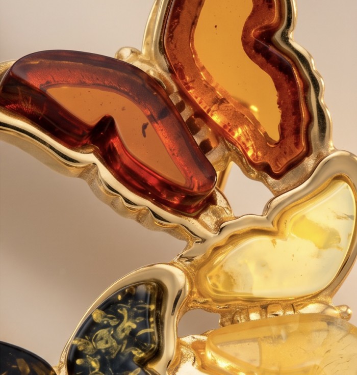 Golden Butterflies Authentic carved Baltic Amber 18K Gold over .925 Sterling Silver handcrafted pendant - Close-up of golden butterfly jewelry with carved Baltic amber stones.