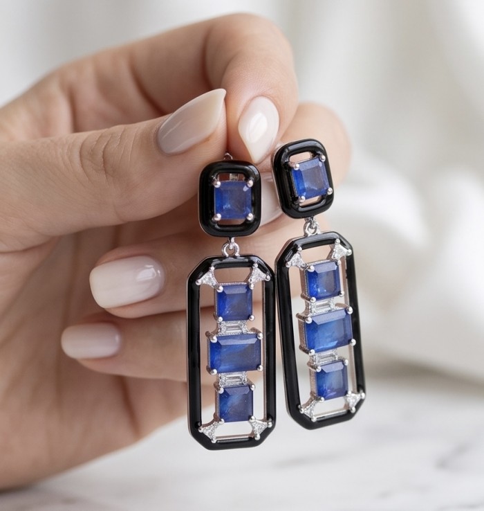 Art Deco 11.5 carat Sapphire black enamel .925 Sterling Silver handcrafted earrings - Close-up of hand holding Art Deco sapphire earrings with black enamel.