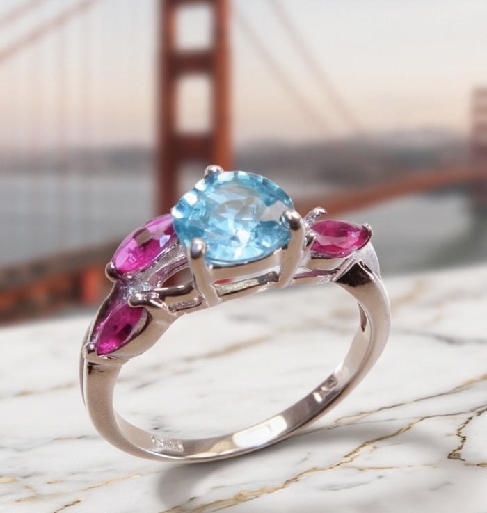Pacifica 3.8 carat Swiss Blue Topaz .925 Sterling Silver handcrafted ring size 7 - Close-up of Pacifica ring with blue topaz and pink stones, silver band.