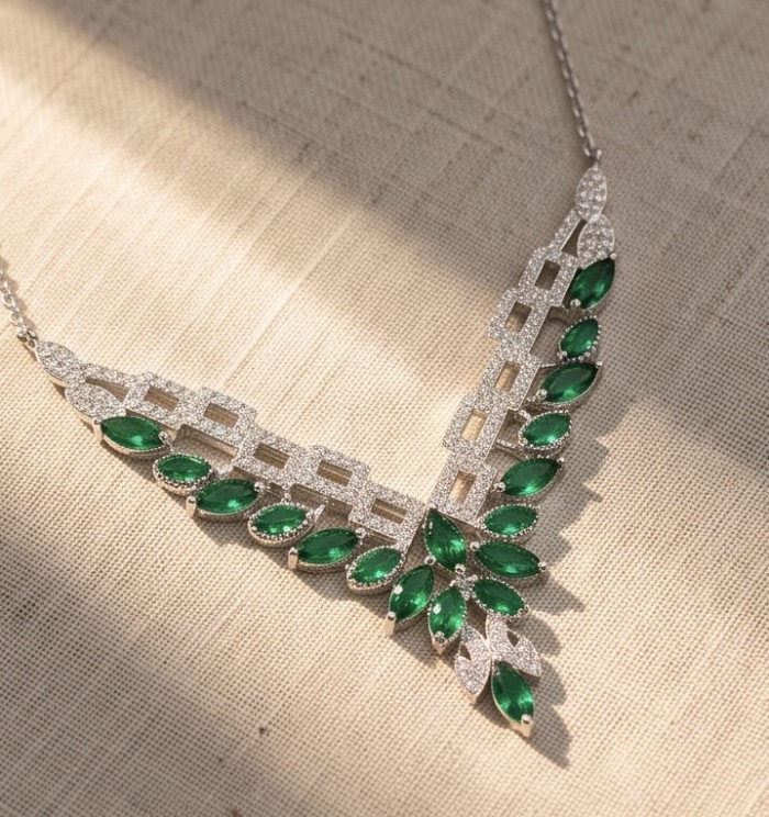 Precious 7.2 carat natural Colombian Emerald rhodium over .925 Sterling Silver .925 Sterling Silver Statement Necklace - Elegant necklace with green marquise emeralds on textured fabric background.