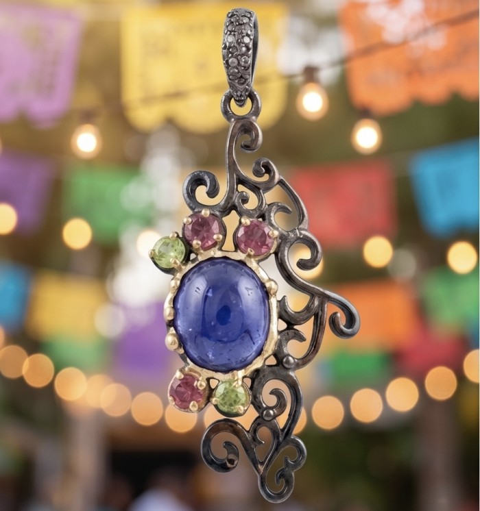 Summer Fiesta 9.5 carat natural Tanzanite black rhodium over .925 Sterling Silver Handcrafted Pendant - Close-up of Summer Fiesta Tanzanite pendant with decorative background