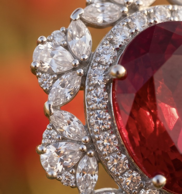 Incredible oval cut 18.8 carat Mozambique Ruby .925 Sterling Silver handcrafted pendant - Close-up of oval Mozambique ruby with diamond accents in silver setting.