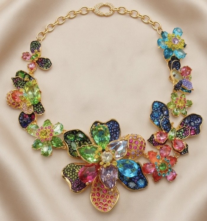 Blooming Garden 145.2 carat Natural multicolot Topaz 14k Gold over .925 Sterling Silver handcrafted Statement necklace - Colorful floral necklace with multicolor topaz stones on a cloth background.