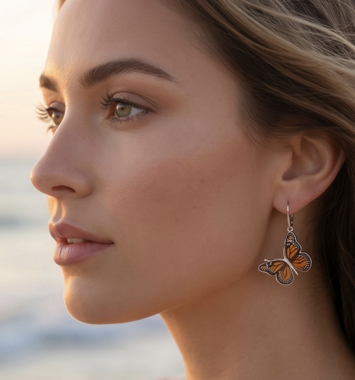 Butterflies carved Baltic Polish Amber 18K Gold over .925 Sterling Silver handcrafted earrings - Side view of butterfly amber earrings worn by model at sunset.