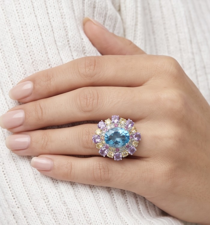 Pacifica - Authentic 33.8 carat Swiss Blue Topaz Rhodium over .925 Sterling Silver handcrafted Large Statement ring size 7 - Blue topaz ring with purple stones worn on hand.