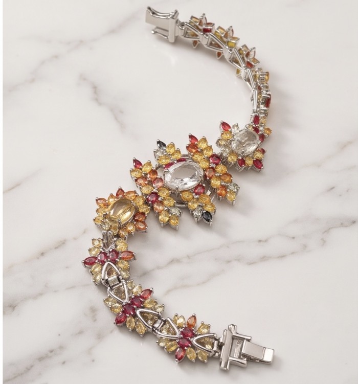 Victoria Authentic 55.5 carat multicolor Sapphire .925 Sterling Silver brilliantly dipped in Rhodium handcrafted Statement Bracelet - Bracelet with multicolor sapphires, top view, showing clasp and intricate design.
