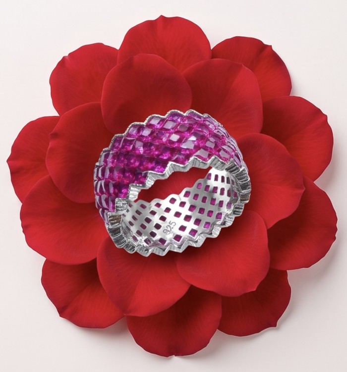 Infinity 10.7 ctw mystery setting Mozambique Ruby .925 Sterling Silver dipped in rhodium handcrafted Statement Ring size 6 1/2 - Infinity ruby ring on red petals, showing top detail, .925 sterling silver.