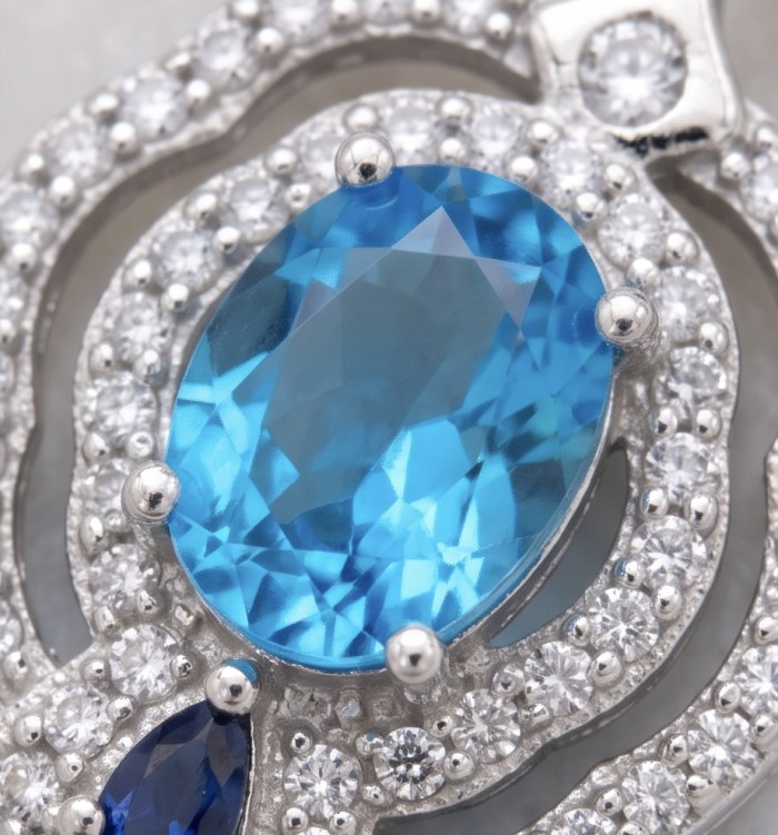 Tranquillity - 4.7 carat carved Swiss Blue Topaz .925 Sterling Silver dipped in Rhodium Handcrafted Statement earrings - Stone close-up of Swiss Blue Topaz with surrounding diamonds