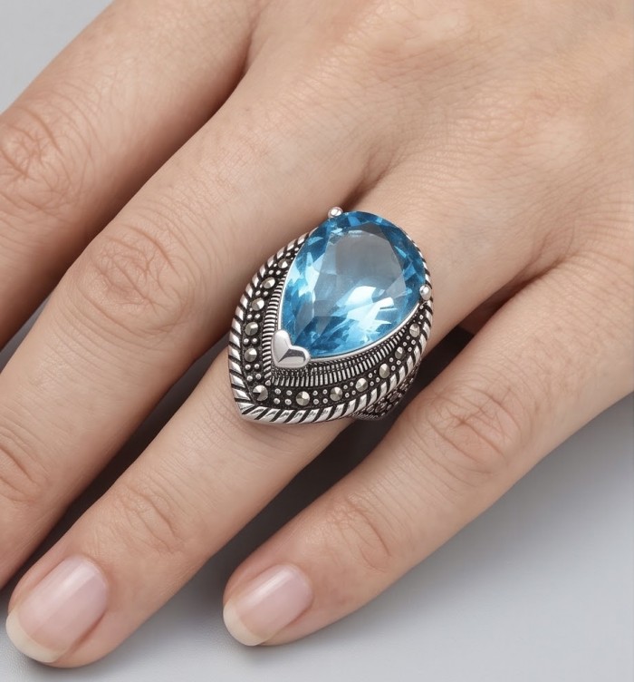 Celestial Peace 20.8 carat Swiss Blue Topaz .925 Sterling Silver dipped in rhodium handcrafted ring size 7 3/4 - Swiss Blue Topaz ring on hand, showcasing intricate silver setting.